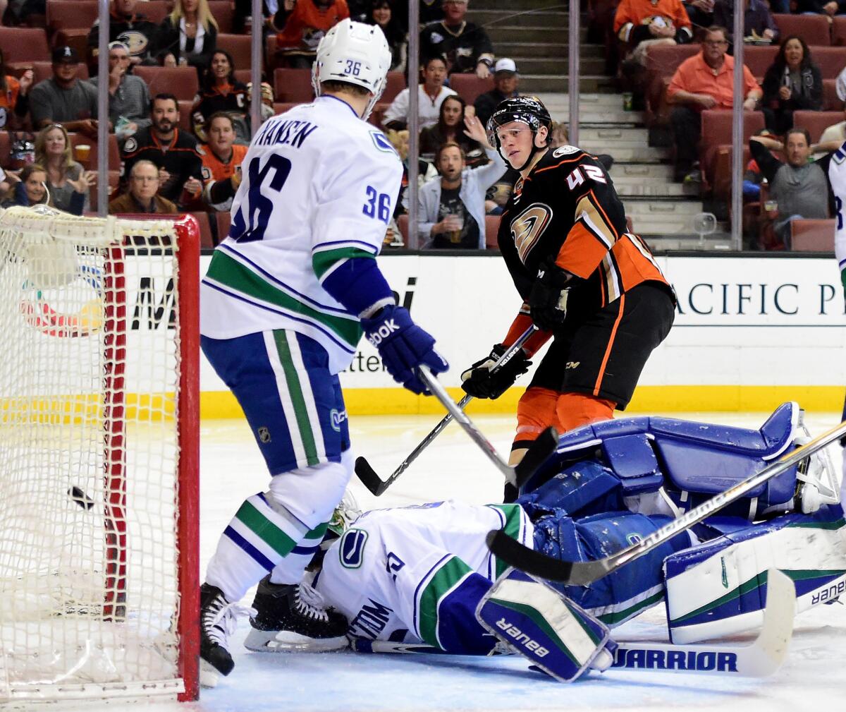 Ducks defenseman Josh Manson scores a goal on Vancouver goalie Jacob Markstrom during the first period of a game April 1 at Honda Center.