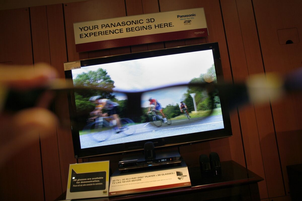 3-D glasses are held up to a 50-inch plasma 3-D television set.