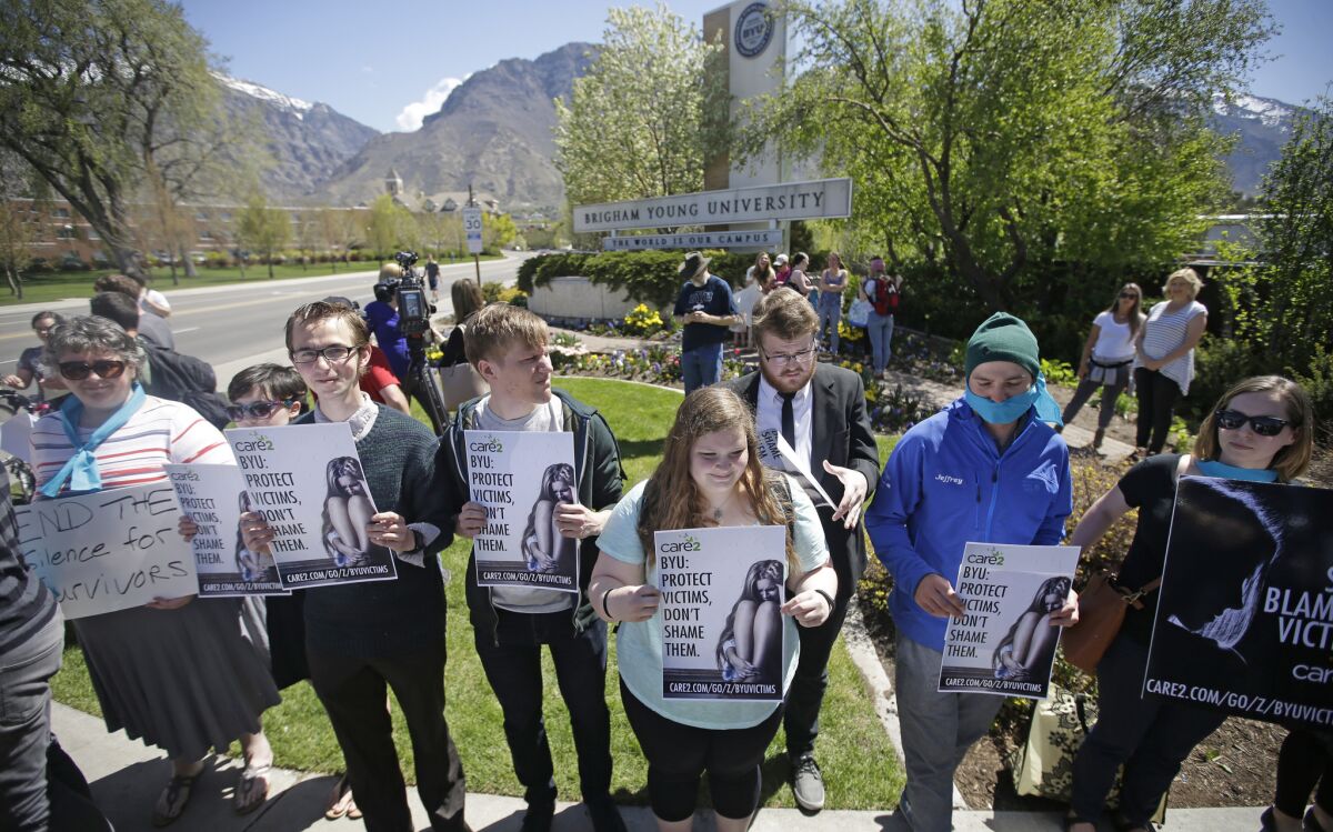 Protesters stand in solidarity with rape victims on the campus of Brigham Young University during a sexual assault awareness demonstration in Provo, Utah on April 20.