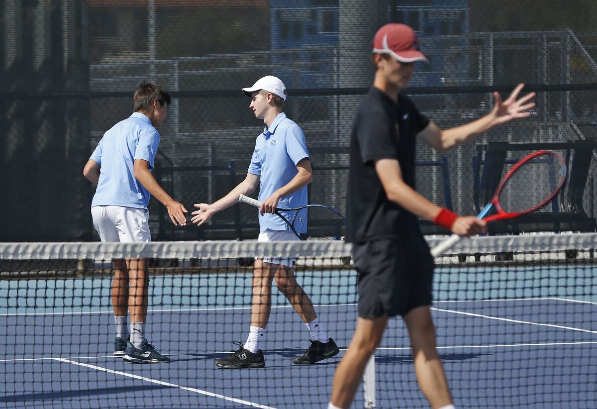 Corona del Mar's No. 1 doubles pair Tristan Pham and Jack Knox, from left, celebrate a point against Palos Verdes Peninsula.