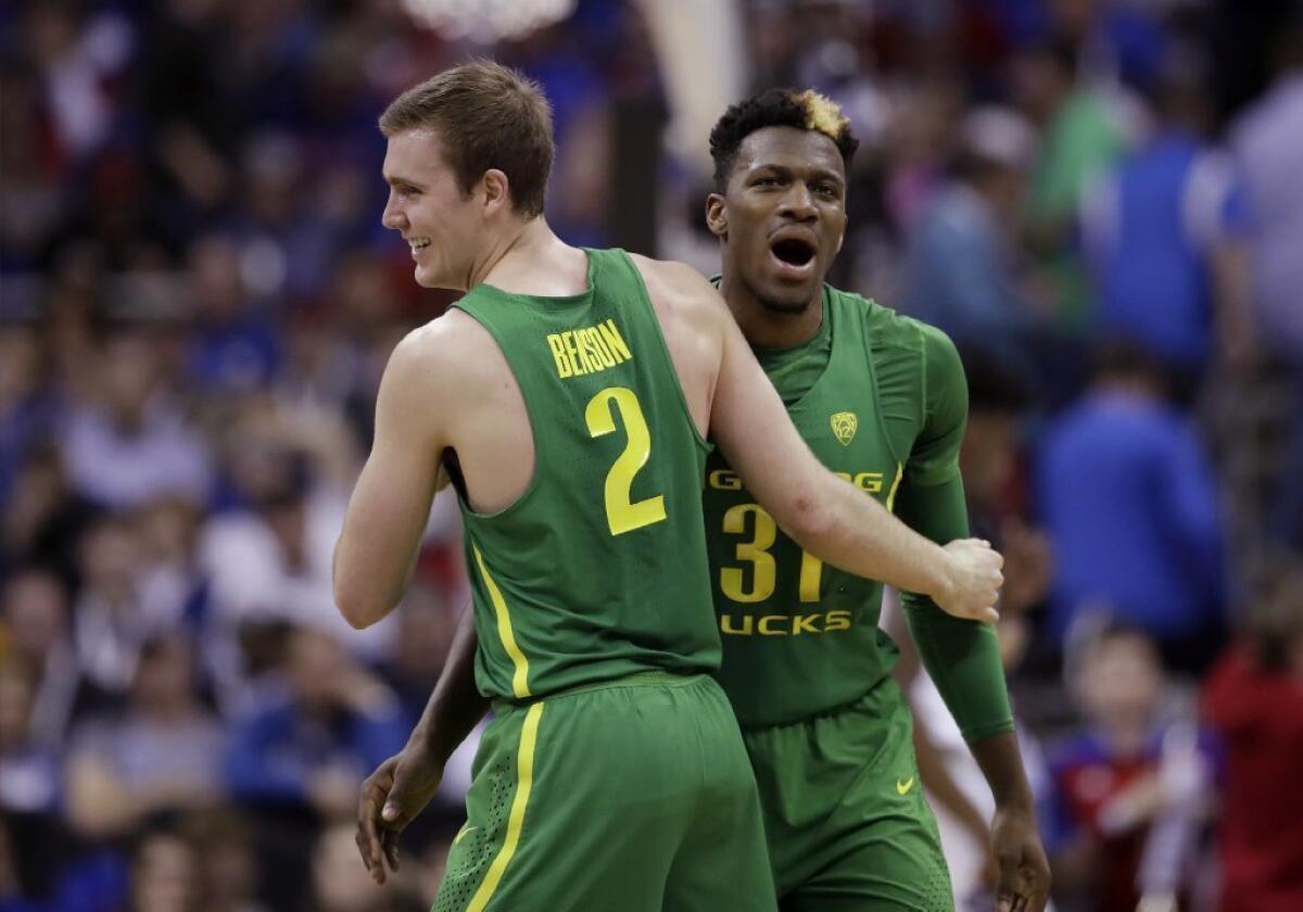 Oregon'a Casey Benson and Dylan Ennis celebrate at the end of the first half an Elite Eight game on the NCAA tournament on March 25.
