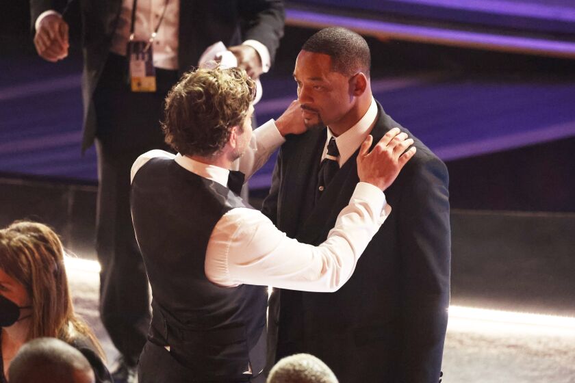 HOLLYWOOD, CA - March 27, 2022. Bradley Cooper comforts Will Smith during the show at the 94th Academy Awards at the Dolby Theatre at Ovation Hollywood on Sunday, March 27, 2022. (Myung Chun / Los Angeles Times)