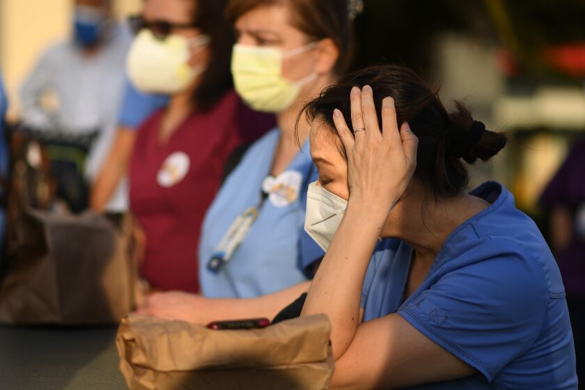 LOS ANGELES, CALIFORNIA MAY 6, 2020-Nurses attend a candlelight vigil for nurse Celia Marcos outside Hollywood Presbyterian Medical Center in Los Angeles Wednesday. Marcos died from the coronavirus. (Wally Skalij/Los Angeles Times)