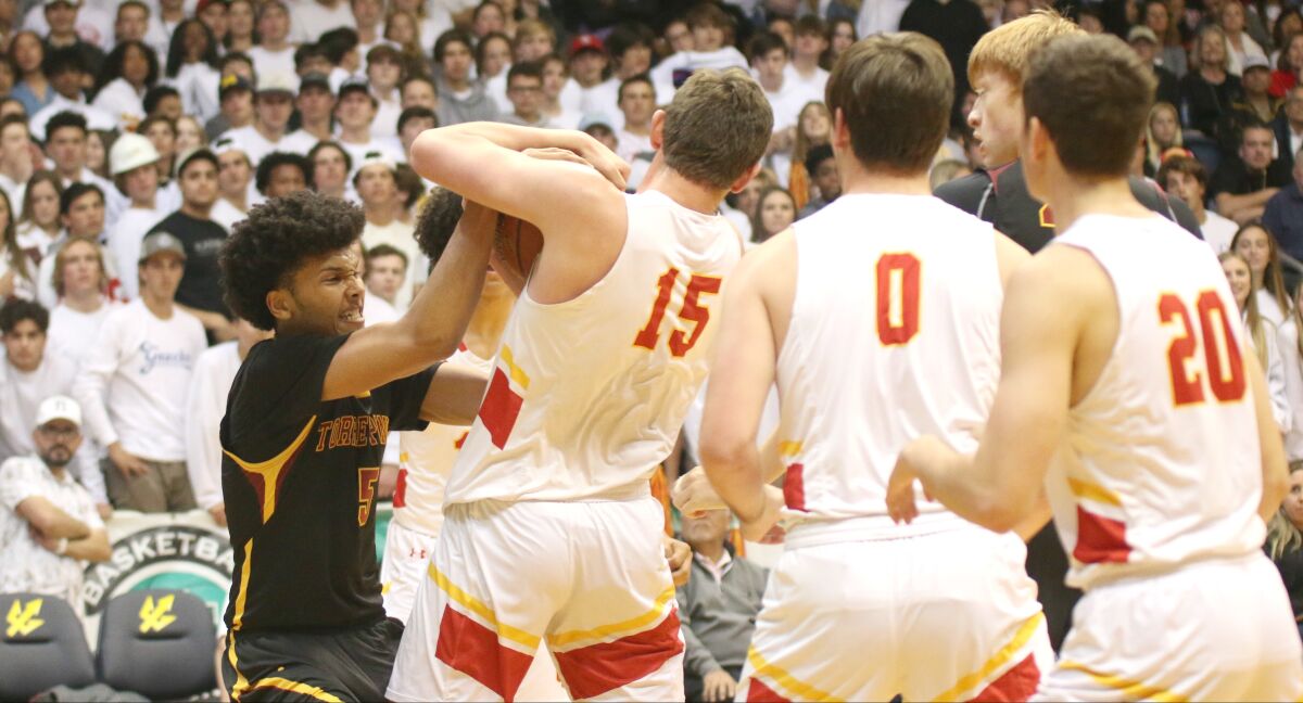 Junior Chris Howell (left) had 12 points and eight rebounds for Torrey Pines.