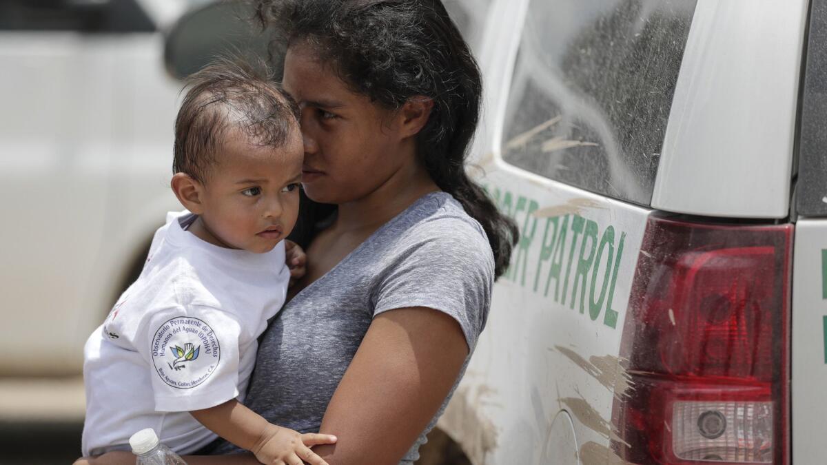 A Honduran woman holds her baby after surrendering to Border Patrol agents in Granjeno, Texas, on June 25.