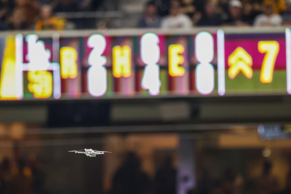 A drone hovers over the field during the seventh inning.