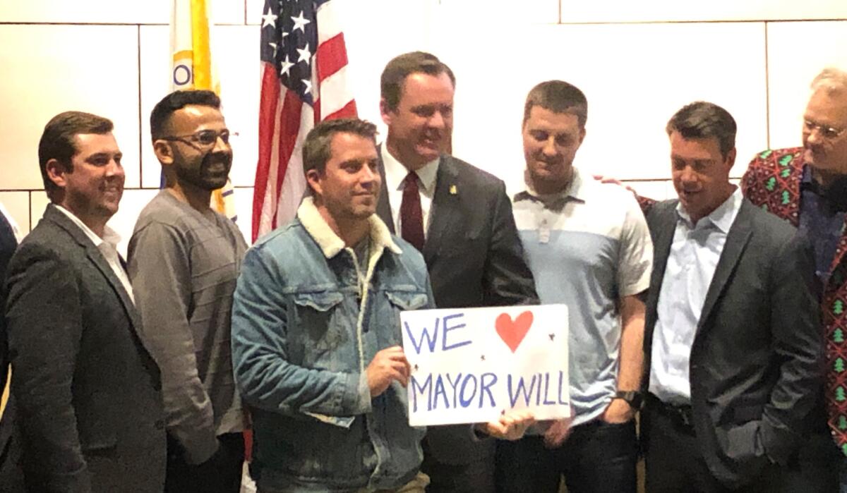 Will O'Neill, center, the new mayor of Newport Beach, is surrounded by supporters during Tuesday night's City Council meeting.