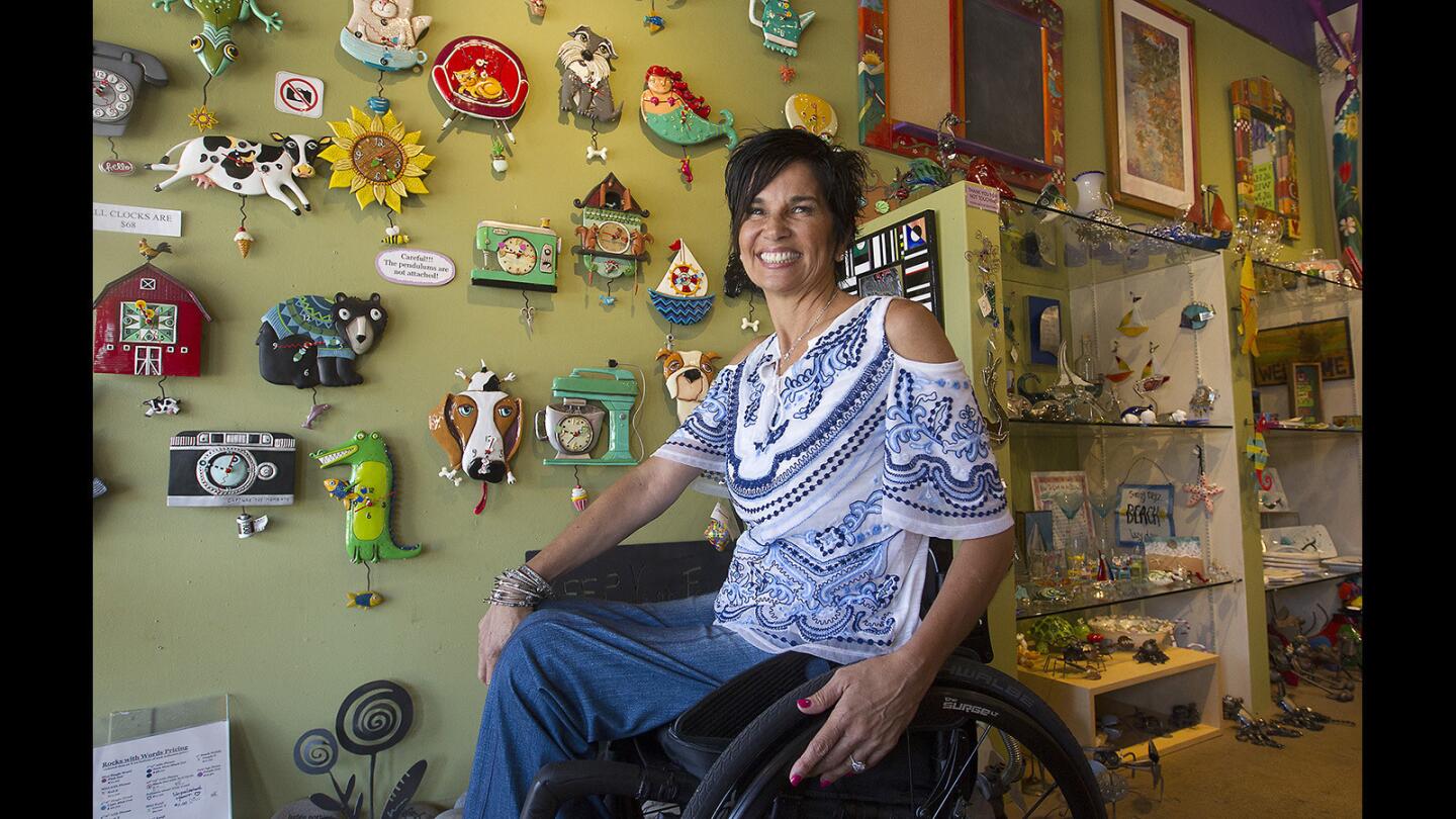 Valinda Martin is all smiles at Art for the Soul, her inspirational gift shop on Balboa Island, which she started as therapy after she became paraplegic after a boating accident.