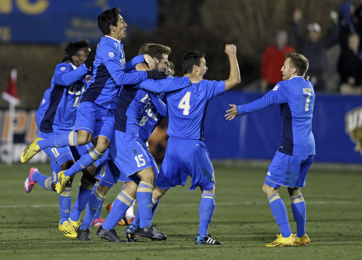 UCLA players celebrate their 3-2 overtime win Friday over Providence in Cary, N.C.