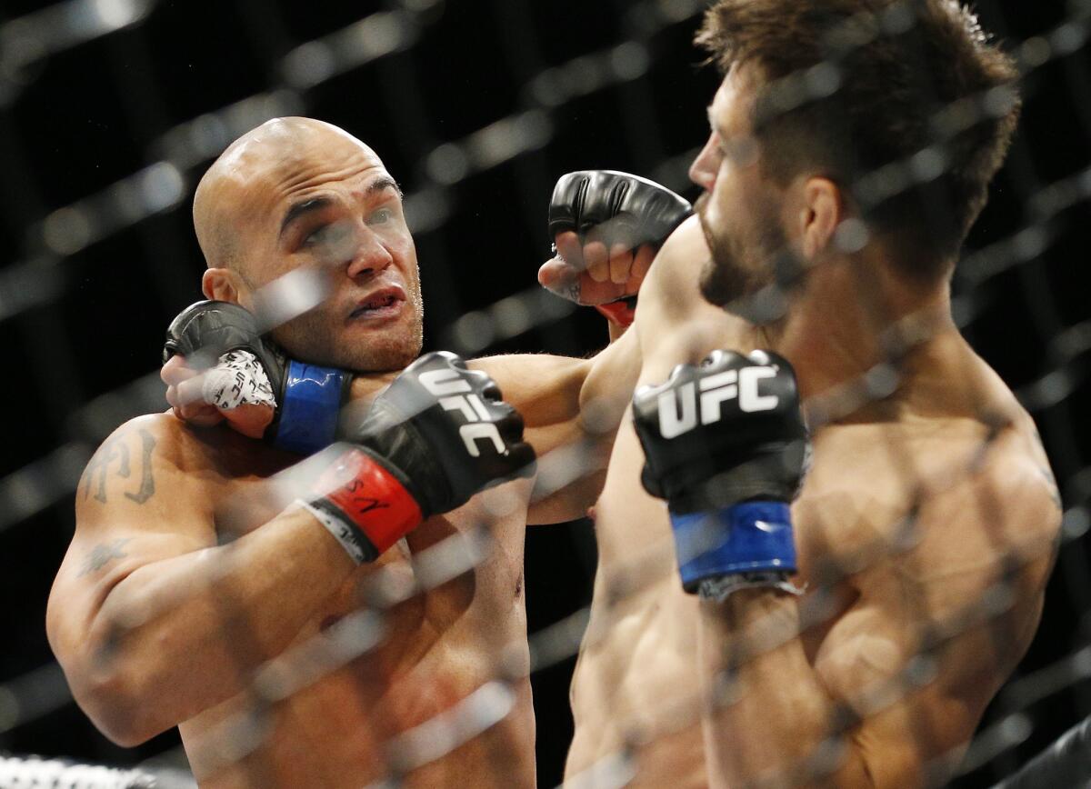 Carlos Condit, right, tries to fend off Robbie Lawler during their welterweight title fight at UFC 195.