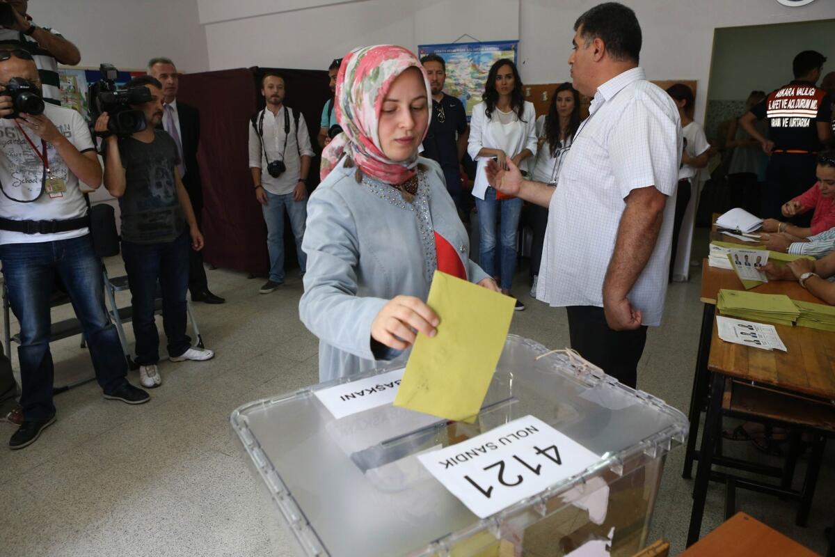 A woman casts her ballot at an Ankara polling station as Turkey holds its first direct presidential election.