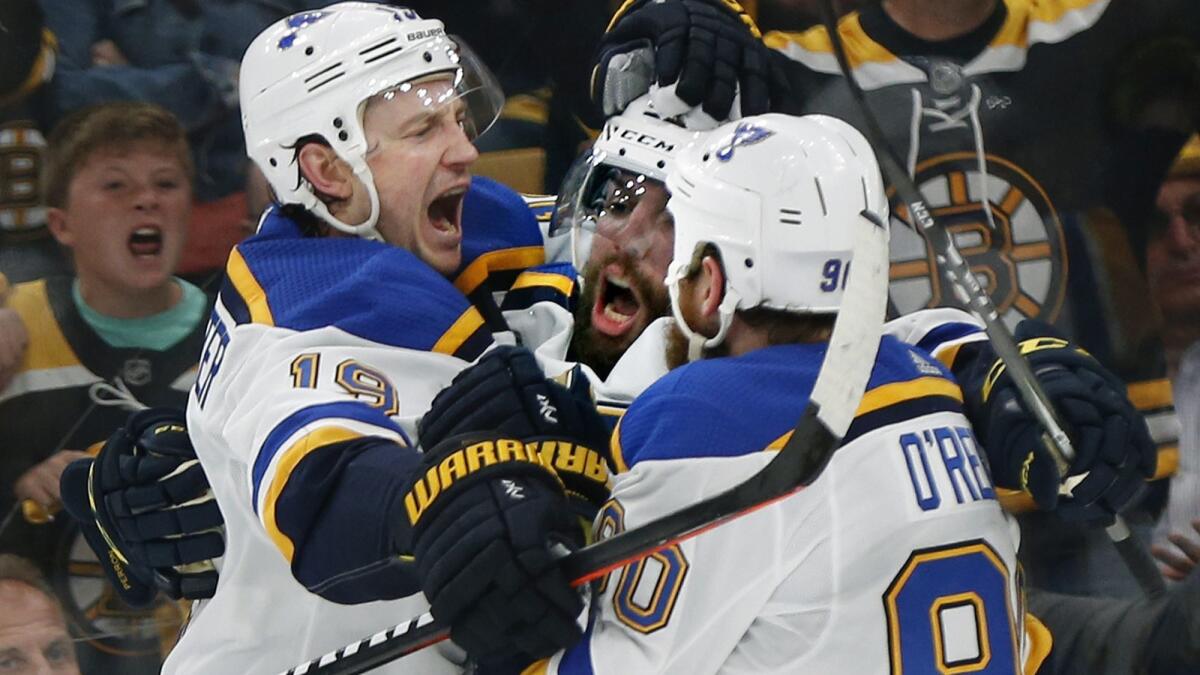 St. Louis Blues' David Perron, center, celebrates his goal against the Boston Bruins with Jay Bouwmeester, left, and Ryan O'Reilly.