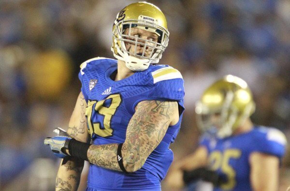 UCLA defensive end Cassius Marsh waits for Nevada to run its next play during the season opener.