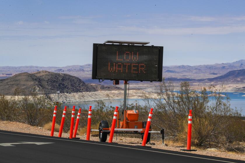 Lake Mead, NV - June 28: A sign warns visitors of the drought's effect at Hemenway Harbor, Lake Mead, Nevada Monday, June 28, 2021. Lake Mead is at its lowest level in history since it was filled 85 years ago, Monday, June 28, 2021. The ongoing drought has made a severe impact on Lake Mead and a milestone in the Colorado River's crisis. High temperatures, increased contractual demands for water and diminishing supply are shrinking the flow into Lake Mead. Lake Mead is the largest reservoir in the U.S., stretching 112 miles long, a shoreline of 759 miles, a total capacity of 28,255,000 acre-feet, and a maximum depth of 532 feet. (Allen J. Schaben / Los Angeles Times)
