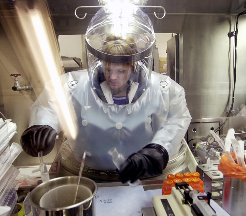 In this May 11, 2003, file photo, a microbiologist works with a BG nerve agent simulant in the Life Sciences Test Facility at Dugway Proving Ground, Utah. The Trump administration has reduced programs meant to limit the risk posed by nerve agents and other weapons of mass destruction.