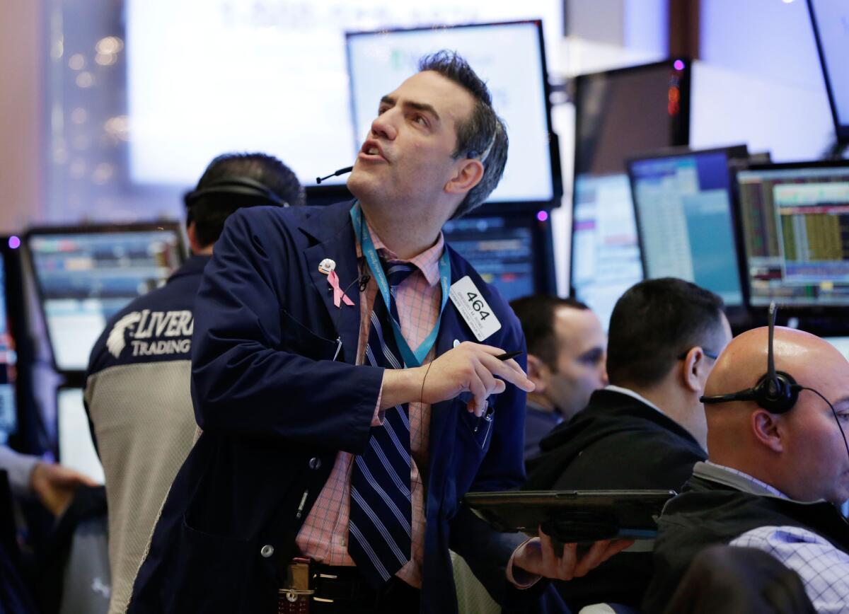 Trader Gregory Rowe works on the floor of the New York Stock Exchange on Monday.