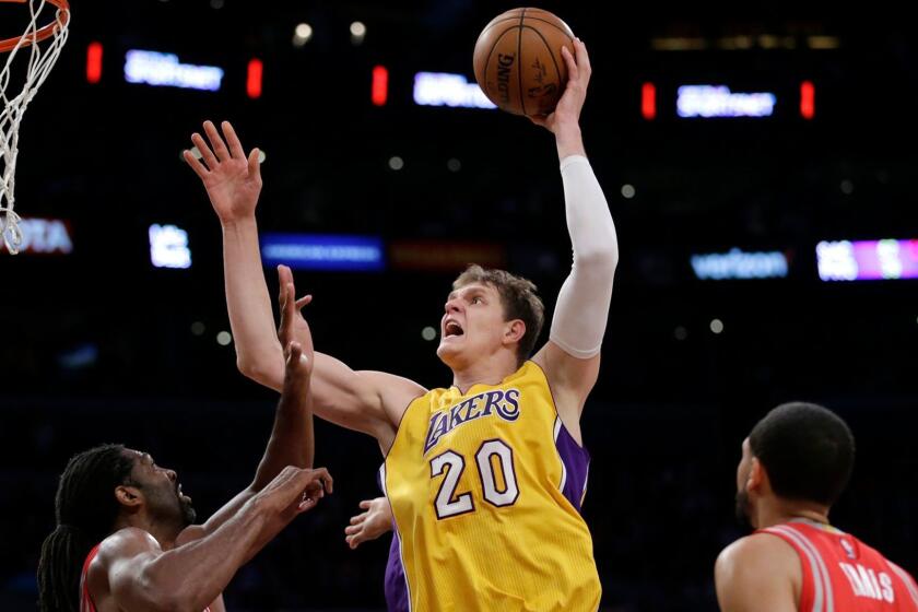 LOS ANGELES, CA, WEDNESDAY, OCTOBE 26, 2016 - Lakes center Timofey Mozgov shoots over Rockets center Nene during first half action at Staples Center. (Robert Gauthier/Los Angeles Times)