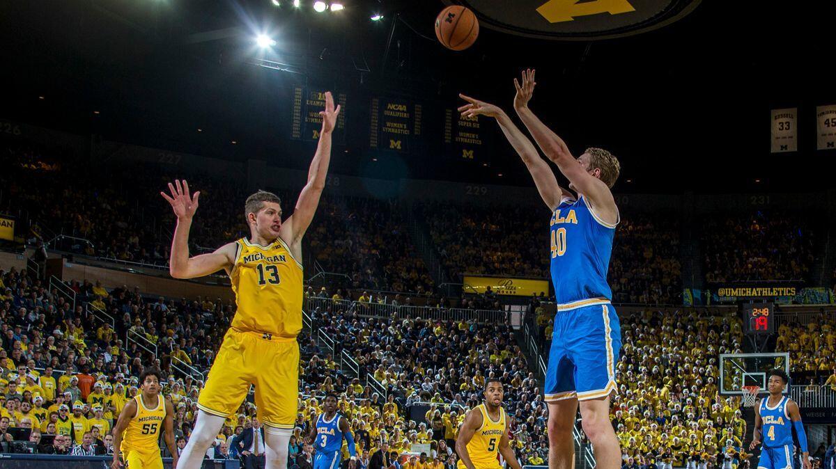 UCLA center Thomas Welsh, right, shoots over Michigan forward Moritz Wagner in the first half last Saturday.
