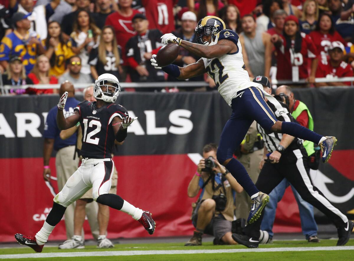 Rams cornerback Trumaine Johnson, right, intercepts a pass intended for Arizona Cardinals wide receiver John Brown during a game Oct. 2.