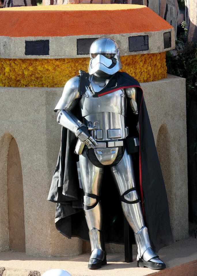 Captain Phasma from Star Wars: The Force Awakens rides in her shiny Stormtrooper armor on the Disneyland Resort float during the 2016 Rose Parade in Pasadena on Friday, Jan. 1, 2016.