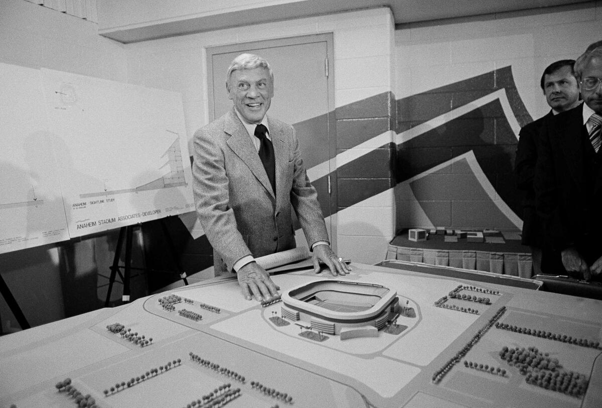 Former Los Angeles Rams owner Carroll Rosenbloom poses with a model of Anaheim Stadium in July 1978.