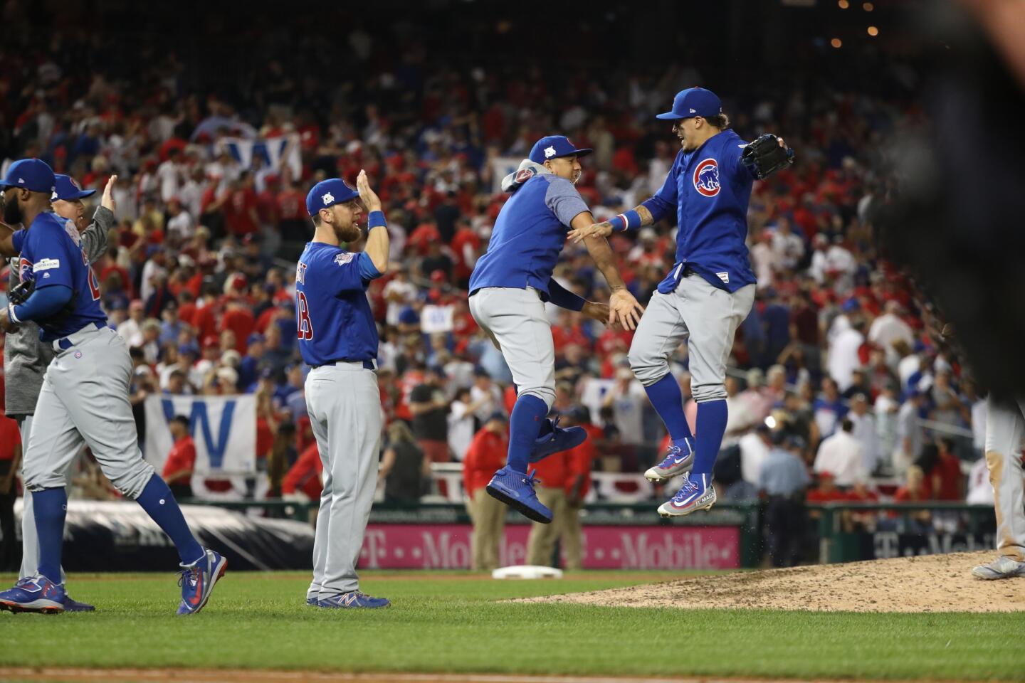 Cubs left fielder Jon Jay and second baseman Javier Baez celebrate the win.