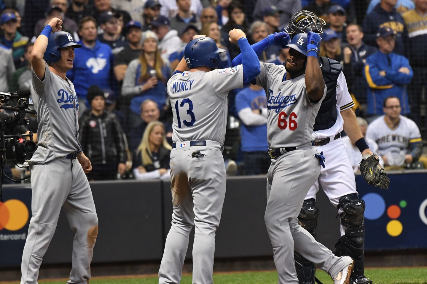 Dodgers Yasiel Puig celebrates with Max Muncy after hitting a three run home run in the 6th inning.