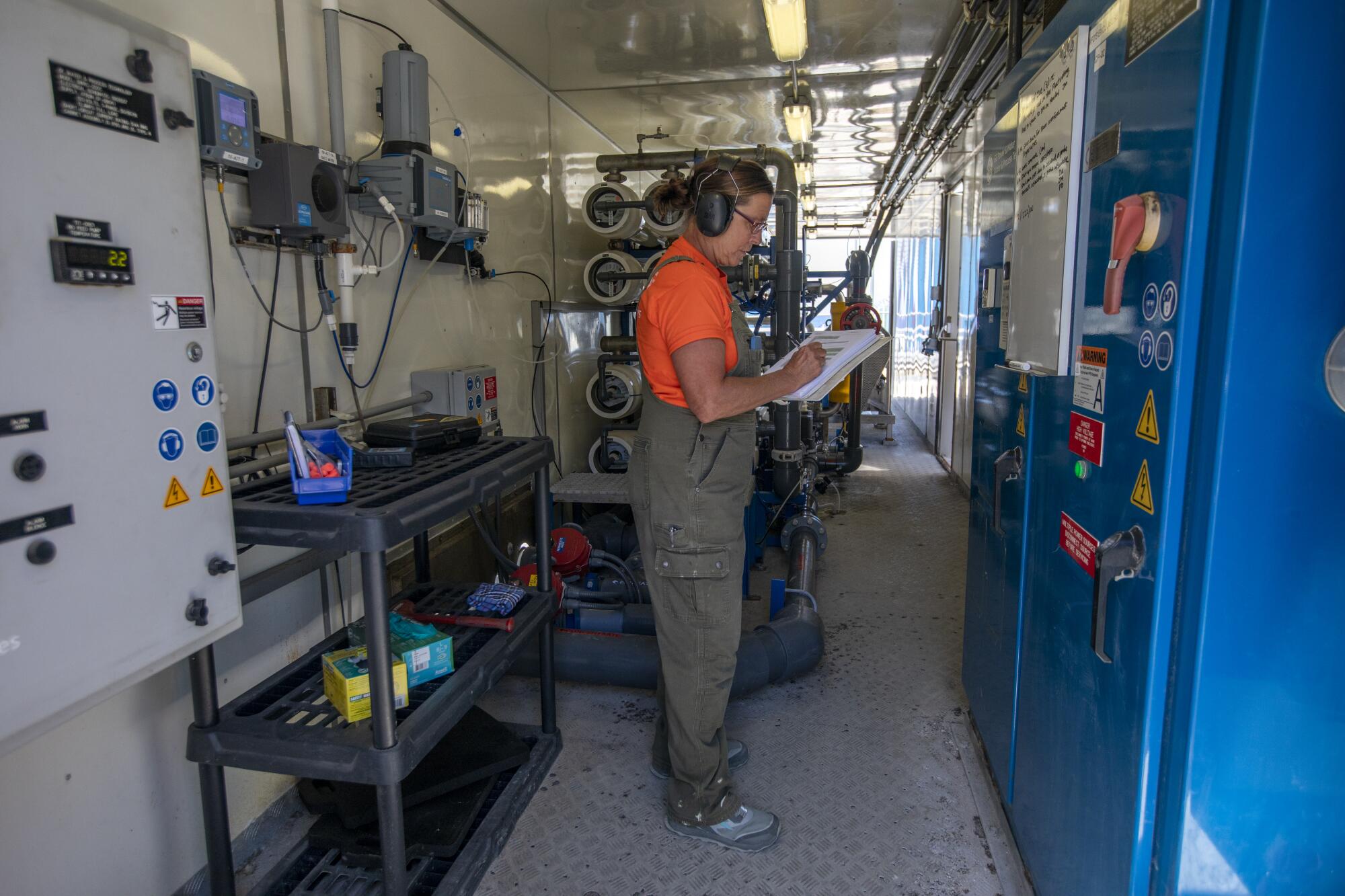 Jessie McDonald checks the numbers inside the desalination plant in Avalon. 