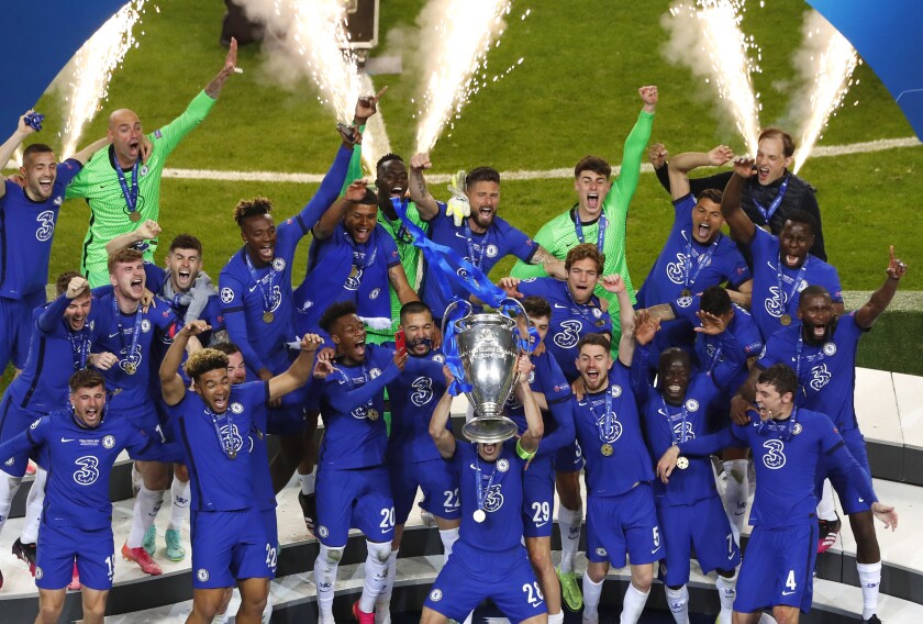 Chelsea players celebrate with the UEFA Champions League trophy 