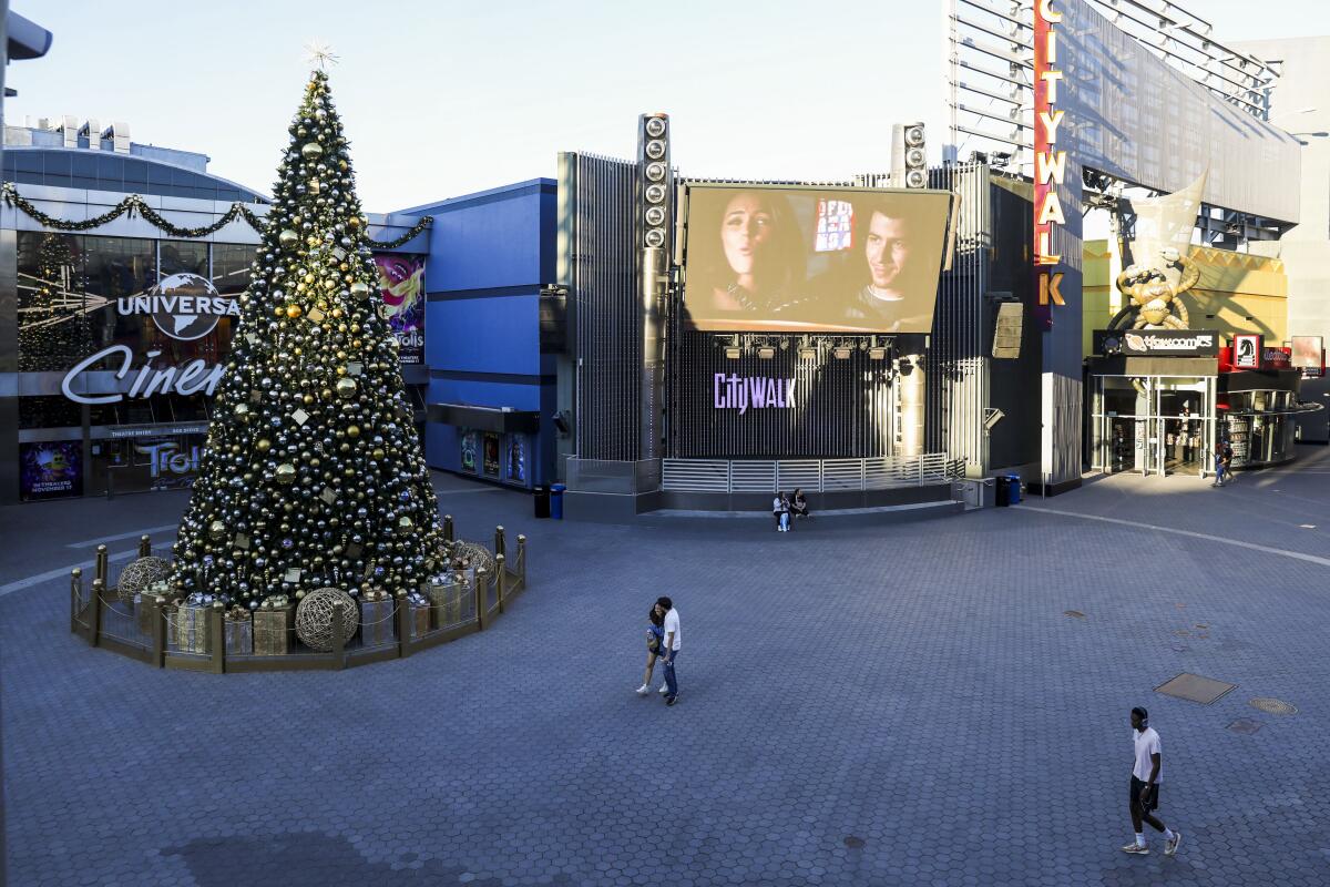 Los Angeles, CA - November 16: People walk by Universal Cinema AMC at City Walk Hollywood on Thursday, Nov. 16, 2023 in Los Angeles, CA. (Michael Blackshire / Los Angeles Times)