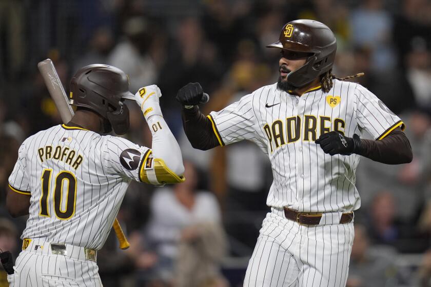 San Diego Padres' Fernando Tatis Jr., right, celebrates with teammate Jurickson Profar after hitting a home run during the eighth inning of a baseball game against the New York Yankees, Saturday, May 25, 2024, in San Diego. (AP Photo/Gregory Bull)