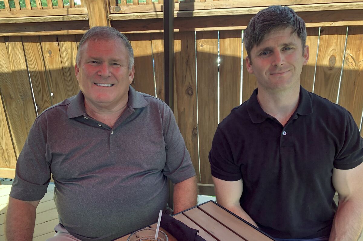 Baby Boomer Buck Newsome, left, lunches with son, Chris Newsome, a Millennial, in Newtown, Ohio. 