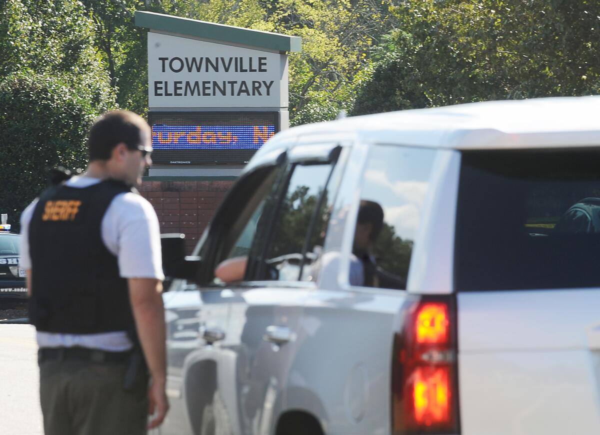 Members of law enforcement talk in front of Townville Elementary School on Wednesday, Sept. 28 in Townville, S.C.