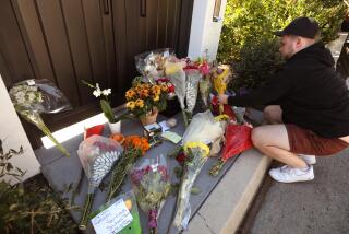PACIFIC PALISADES, CA - OCTOBER 30, 2023 - Samuel Miller, 26, leaves flowers at a growing memorial for actor Matthew Perry in front of his home in Pacific Palisades on October 30, 2023. "I just grew up watching Friends. It got me through a lot of hard times," Miller said. "It makes me sad," said Miller about the passing of the actor. (Genaro Molina / Los Angeles Times)