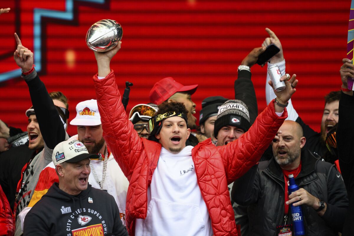 Kansas City Chiefs quarterback Patrick Mahomes and teammates react to the crowd during the Chiefs' victory celebration and parade in Kansas City, Mo., Wednesday, Feb. 15, 2023. The Chiefs defeated the Philadelphia Eagles Sunday in the NFL Super Bowl 57 football game. (AP Photo/Reed Hoffmann)