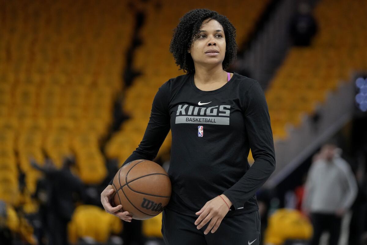 Sacramento Kings assistant coach Lindsey Harding watches players warm up before a playoff game in 2023.