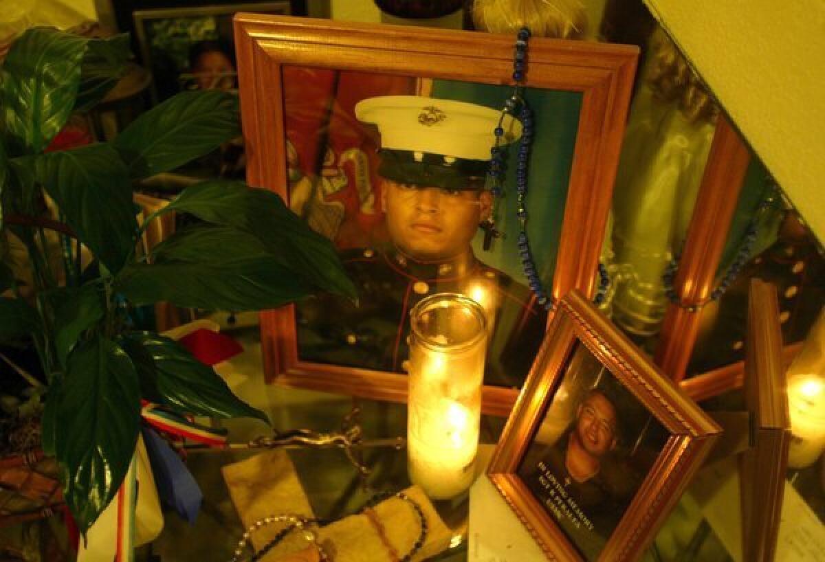 A photo and a burning candle in memory of Rafael Peralta, killed in the battle for Falluja. This photo was taken at the Peralta home in San Diego in 2004.