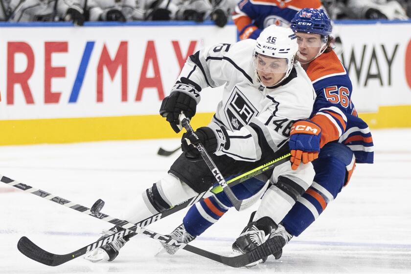 Los Angeles Kings' Blake Lizotte (46) and Edmonton Oilers' Kailer Yamamoto (56) battle for the puck