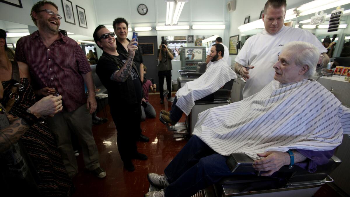 Harlan Ellison gets a haircut as fans watch before a 2013 book signing. The writer is recovering from a stroke he had last week.