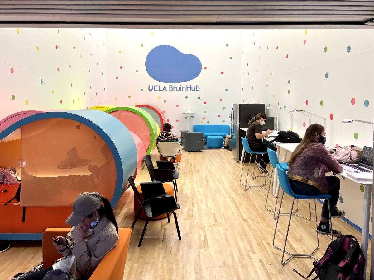 Students sit at worktables while others can be seen inside sleep pods in a lounge area.