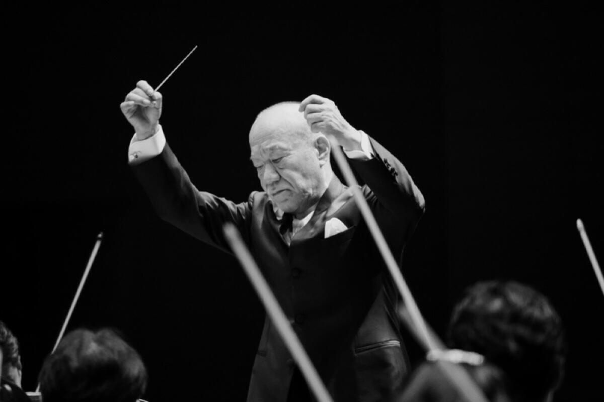 Joe Hisaishi conducts an orchestra.