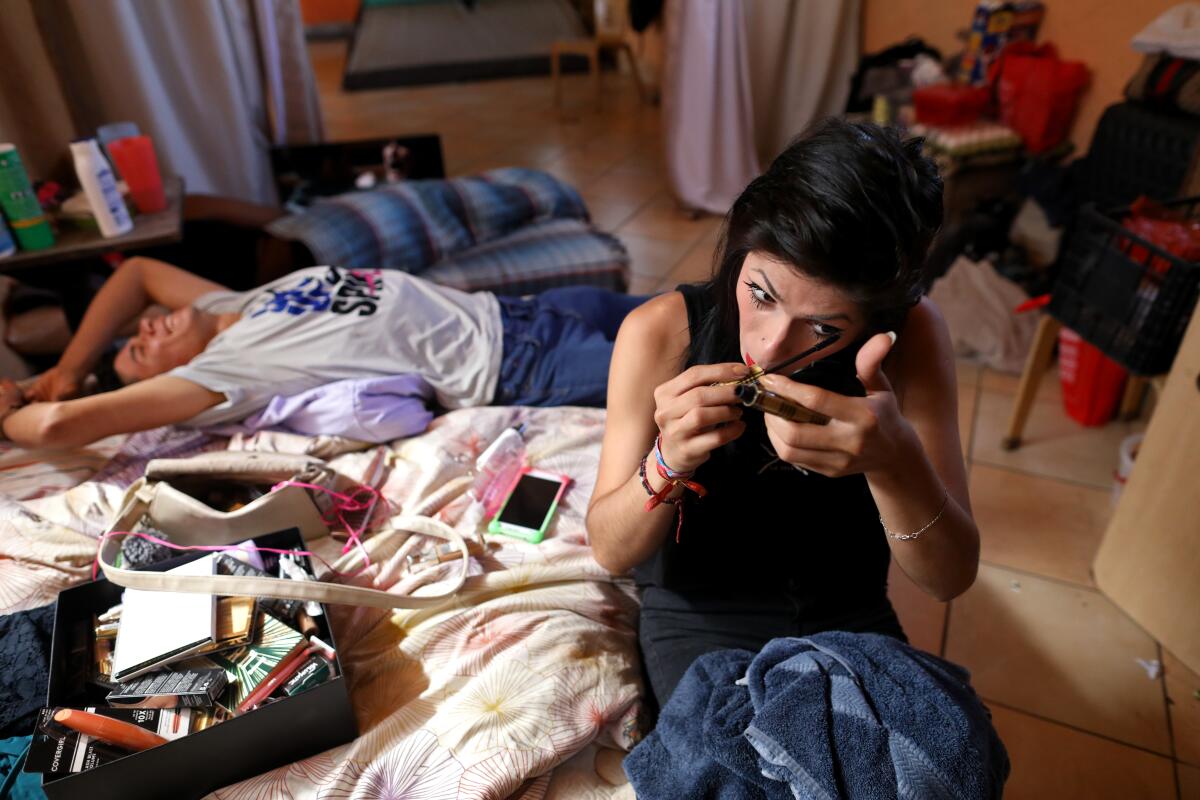 Katherine Hernandez, 24, right, of Tegucigalpa, Honduras, a transgender woman, fled her hometown after gangs threatened her for sexual orientation, waits for an asylum hearing at the Casa de Luz collective housing in Tijuana, Baja Calif., on Oct. 8, 2019. Many in the community are seeking political asylum for having received threats in their home countries for their sexual orientation.