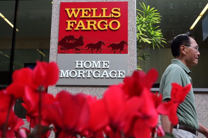 SAN FRANCISCO, CA - OCTOBER 11: A pedestrian walks by a Wells Fargo home mortgage office on October 11, 2013 in San Francisco, California. Wells Fargo reported a 13 percent increase in third-quarter profits with a net income of $5.6 billion, or 99 cents a share compared to $4.9 billion, or 88 cents a share one year ago. (Photo by Justin Sullivan/Getty Images) ** OUTS - ELSENT, FPG, CM - OUTS * NM, PH, VA if sourced by CT, LA or MoD **
