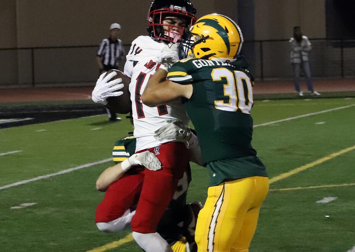 Edison's Jude Gonterman (30) makes a tackle against Palos Verdes on Friday in a nonleague game at Huntington Beach High.