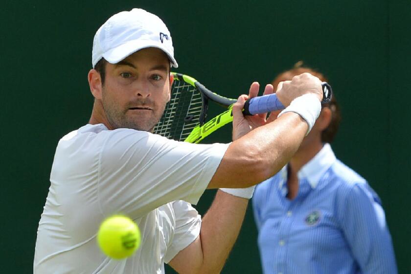 Brian Baker returns against Marin Cilic during the first round at Wimbledon.