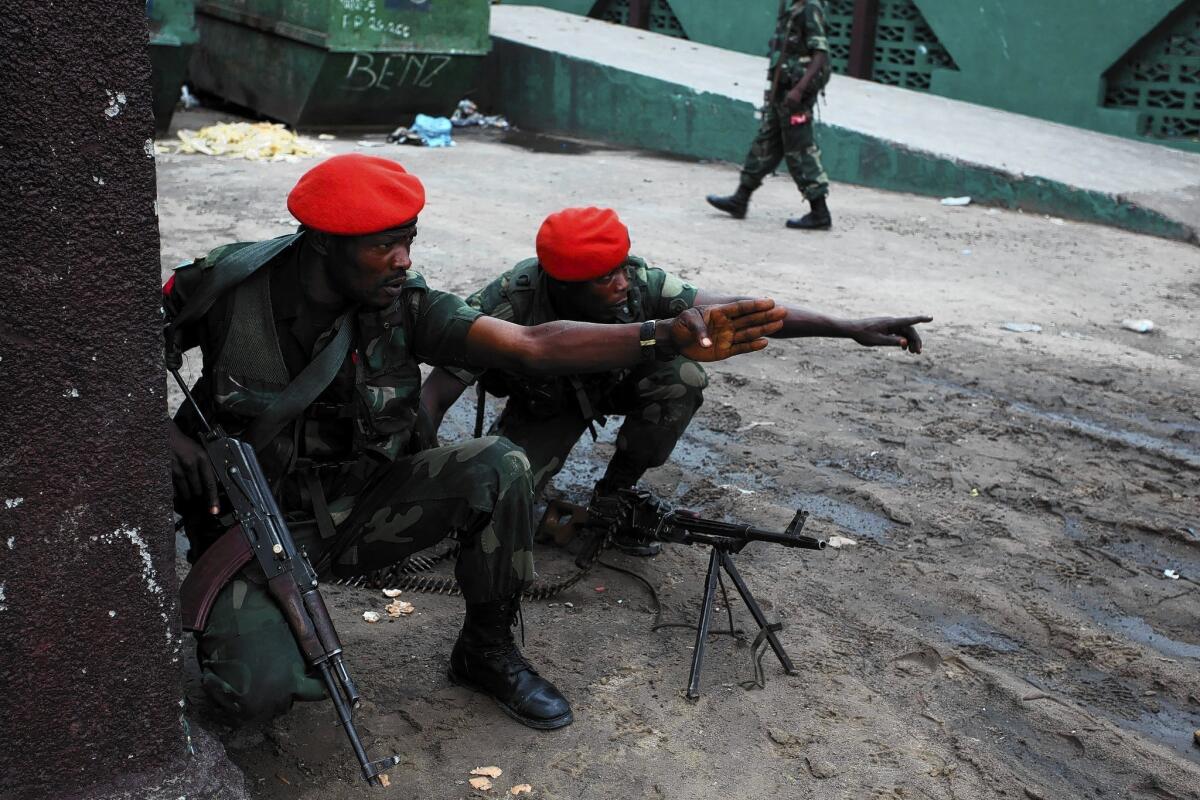 Congolese military police are deployed near the state broadcaster, which was briefly seized during unrest this week in Kinshasa, the capital.