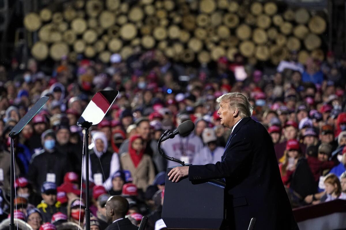 Trump supporters listen as he speaks at a Duluth rally.