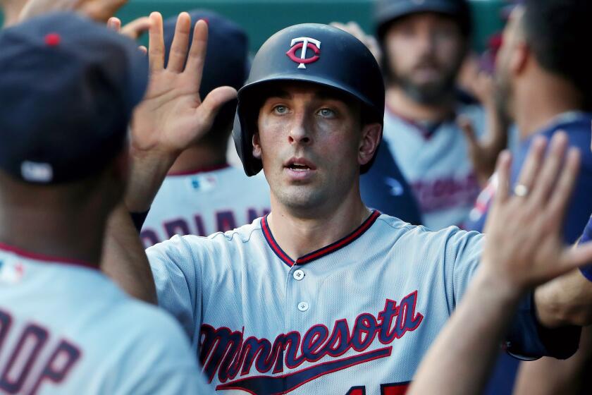 ARLINGTON, TEXAS - AUGUST 15: Jason Castro #15 of the Minnesota Twins celebrates after scoring on a throwing error by Elvis Andrus #1 of the Texas Rangers in the top of the second inning at Globe Life Park in Arlington on August 15, 2019 in Arlington, Texas. (Photo by Tom Pennington/Getty Images)