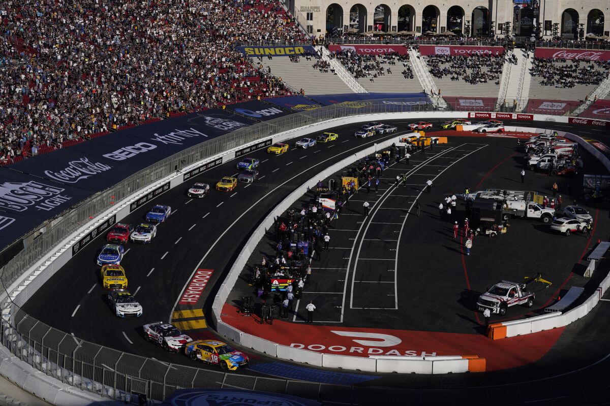 Competitors make a turn during a NASCAR exhibition auto race at Los Angeles. 