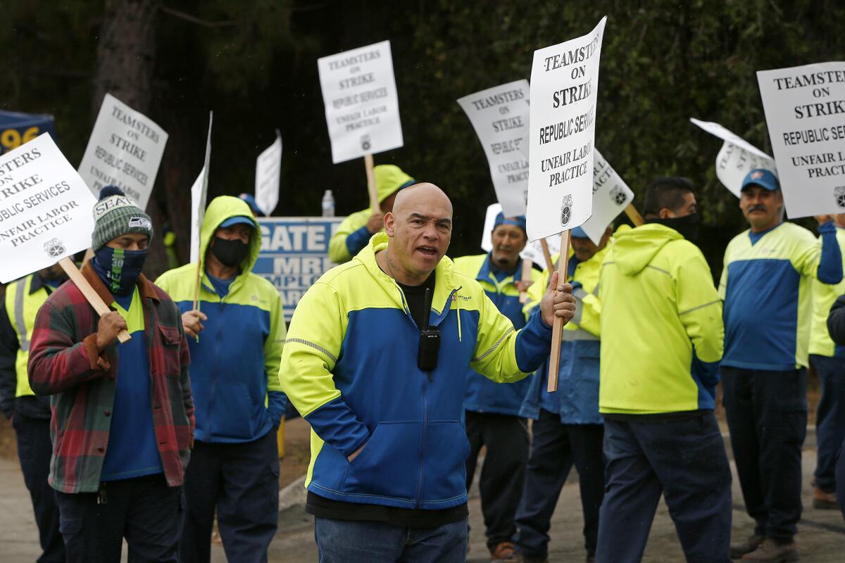 Members of Teamsters Local 396 on strike Thursday at the Republic Services facility in Huntington Beach.